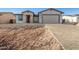 Modern home exterior with a two-car garage and paver driveway at 6208 S Eagle Pass Rd, Gold Canyon, AZ 85118