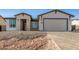 New construction home with brick and white exterior, two-car garage, and paver driveway at 6208 S Eagle Pass Rd, Gold Canyon, AZ 85118