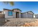 New construction home with brick and white exterior, two-car garage, and paver driveway at 6208 S Eagle Pass Rd, Gold Canyon, AZ 85118