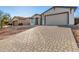 New construction home with a two-car garage and paver driveway at 6208 S Eagle Pass Rd, Gold Canyon, AZ 85118