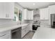 Modern kitchen with white cabinets, farmhouse sink, and stainless steel appliances at 6208 S Eagle Pass Rd, Gold Canyon, AZ 85118