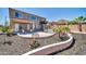 Landscaped backyard with a fire pit and seating area at 6618 W Red Fox Rd, Phoenix, AZ 85083