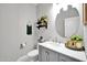 Modern bathroom with gray vanity and marble countertop at 6618 W Red Fox Rd, Phoenix, AZ 85083