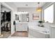 Elegant bathroom featuring a soaking tub, double vanity, and walk-in closet at 6618 W Red Fox Rd, Phoenix, AZ 85083