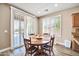 Kitchen breakfast nook with a wooden table and chairs, and sliding doors leading outside at 6618 W Red Fox Rd, Phoenix, AZ 85083