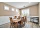 Dining room featuring a large wooden table and white wainscoting at 6618 W Red Fox Rd, Phoenix, AZ 85083