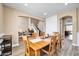 Bright dining room with hardwood floors and a wooden table at 6618 W Red Fox Rd, Phoenix, AZ 85083