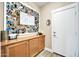 Inviting entryway with wood cabinets and a photo collage at 6618 W Red Fox Rd, Phoenix, AZ 85083