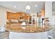 Gourmet kitchen with granite countertops and wood cabinets at 6618 W Red Fox Rd, Phoenix, AZ 85083