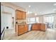 Island kitchen with wood cabinets, granite countertops, and stainless steel dishwasher at 6618 W Red Fox Rd, Phoenix, AZ 85083