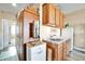 Compact kitchenette with wood cabinets, sink and refrigerator at 6618 W Red Fox Rd, Phoenix, AZ 85083