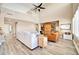 Spacious living room with high ceilings, a large sectional sofa, and a wooden cabinet at 6618 W Red Fox Rd, Phoenix, AZ 85083