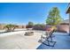 Relaxing patio with fire pit and rocking chairs at 6618 W Red Fox Rd, Phoenix, AZ 85083