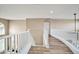 Upstairs hallway with white railing and wood-look flooring at 6618 W Red Fox Rd, Phoenix, AZ 85083