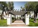 Community entrance with pergola and landscaped walkway at 6840 E 2Nd St # 14, Scottsdale, AZ 85251