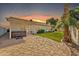 Backyard with hot tub, patio, and grassy area at sunset at 710 S Monterey St, Gilbert, AZ 85233