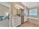 Bathroom with double vanity, linen cabinet and a view of bedroom at 710 S Monterey St, Gilbert, AZ 85233