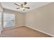 Spacious bedroom with ceiling fan and large window at 710 S Monterey St, Gilbert, AZ 85233