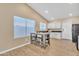 Kitchen with island and seating, hardwood floors and white cabinets at 710 S Monterey St, Gilbert, AZ 85233