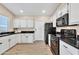 Modern kitchen featuring white cabinets and black countertops at 710 S Monterey St, Gilbert, AZ 85233