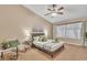 Main bedroom with ceiling fan and view into bathroom at 710 S Monterey St, Gilbert, AZ 85233