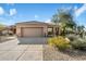 Single-story home with a two-car garage and desert landscaping at 7105 E Hibiscus Way, Scottsdale, AZ 85266