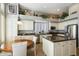 Bright kitchen with granite countertops, island, and white cabinets at 7105 E Hibiscus Way, Scottsdale, AZ 85266