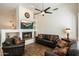 Living room with a fireplace, hardwood floors, and leather furniture at 7105 E Hibiscus Way, Scottsdale, AZ 85266