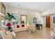 Bright living room with plantation shutters, neutral decor, and a grand piano at 7105 E Hibiscus Way, Scottsdale, AZ 85266