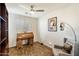 Home office with built-in bookcases, a roll top desk, and comfortable seating at 7105 E Hibiscus Way, Scottsdale, AZ 85266