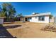 Home's backyard with covered patio and large yard at 7213 W Osborn Rd, Phoenix, AZ 85033