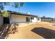 Home's backyard with covered patio and large yard at 7213 W Osborn Rd, Phoenix, AZ 85033