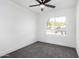 Bright bedroom with ceiling fan and neutral carpeting at 7213 W Osborn Rd, Phoenix, AZ 85033