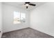 Bright bedroom with grey carpet and ceiling fan at 7213 W Osborn Rd, Phoenix, AZ 85033