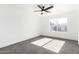 Bright bedroom with grey carpet and ceiling fan at 7213 W Osborn Rd, Phoenix, AZ 85033