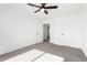 Spacious bedroom with grey carpet and ceiling fan at 7213 W Osborn Rd, Phoenix, AZ 85033