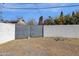 Backyard access with a metal gate between block walls at 740 W Tuckey Ln, Phoenix, AZ 85013