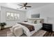 Bright bedroom with a king-size bed and ceiling fan at 740 W Tuckey Ln, Phoenix, AZ 85013