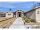 Updated mid-century home with a modern facade and walkway at 740 W Tuckey Ln, Phoenix, AZ 85013