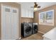 Laundry room with washer, dryer, and cabinets at 740 W Tuckey Ln, Phoenix, AZ 85013