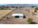 Aerial view of a large metal barn with attached stalls at 7528 N 185Th Ave, Waddell, AZ 85355