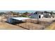 Aerial view showing a metal barn with attached stalls and fencing at 7528 N 185Th Ave, Waddell, AZ 85355