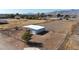 Aerial view of a metal barn with an attached stall and garage at 7528 N 185Th Ave, Waddell, AZ 85355