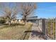 Landscaped backyard with a brick pathway, trees, and a playset near the house at 7528 N 185Th Ave, Waddell, AZ 85355