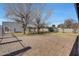 Brick paved patio area in backyard with mature trees and a playset at 7528 N 185Th Ave, Waddell, AZ 85355