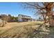 Spacious backyard featuring a grassy lawn, mature trees, and a view of the home at 7528 N 185Th Ave, Waddell, AZ 85355