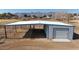 Large metal barn with covered stalls and roll-up door at 7528 N 185Th Ave, Waddell, AZ 85355