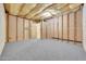 Unfinished basement with carpeted floor and framed walls at 7528 N 185Th Ave, Waddell, AZ 85355