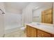 Clean bathroom with wood vanity and a shower/tub combo at 7528 N 185Th Ave, Waddell, AZ 85355