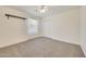 Well-lit bedroom featuring carpet, ceiling fan and double-door closet at 7528 N 185Th Ave, Waddell, AZ 85355